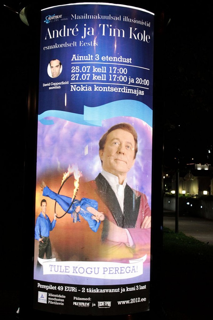 Illuminated poster of Andre's show in downtown Tallinn park at night